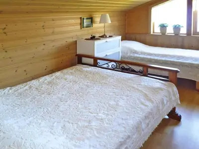 a bedroom with two beds and a table in it at 6 person holiday home in TYSSE-By Traum in Tysse