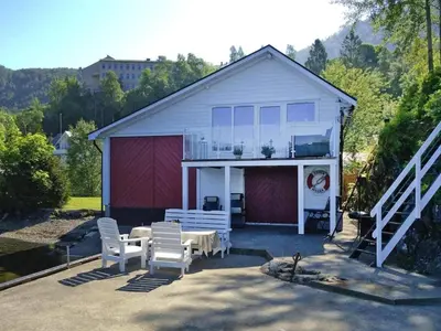 a white house with a table and white chairs at 6 person holiday home in TYSSE-By Traum in Tysse
