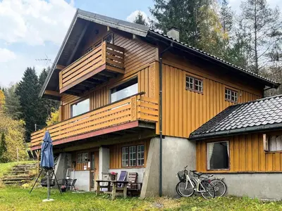 a large wooden house with bikes parked in front of it at 2 person holiday home in STRYN-By Traum in Stryn