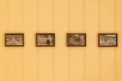 a wall with four framed pictures on a wall at Husum Hotel in Borgund