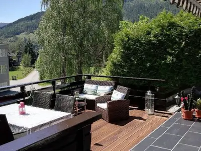 a patio with chairs and a table on a deck at Fagre Stryn Feriehus in Stryn