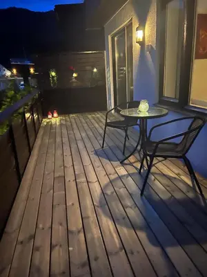 a table and chairs on a deck at night at Fagre Stryn Feriehus in Stryn