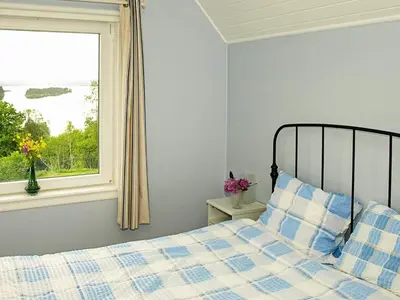 a bedroom with a bed and a window at 6 person holiday home in LONEVÅG-By Traum in Lonevåg
