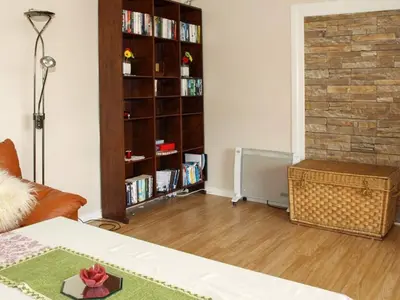 a living room with a book shelf filled with books at 6 person holiday home in LONEVÅG-By Traum in Lonevåg