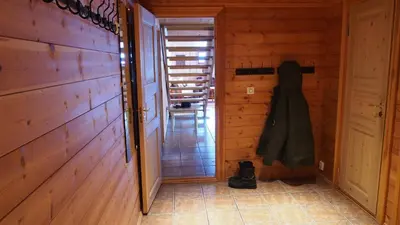a hallway in a wooden cabin with a coat on the wall at Hemsedal Høyfjellssenter in Hemsedal