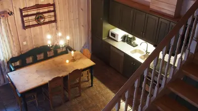 a kitchen with a wooden table with a candle on it at Hemsedal Høyfjellssenter in Hemsedal