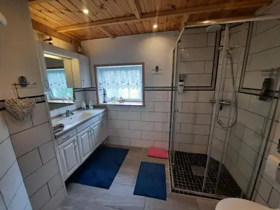 a bathroom with a shower and a sink at Fjordgaestehaus in Innfjorden