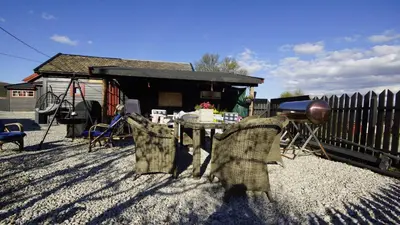 a patio with a table and chairs in a yard at Snøhetta Camping in Hjerkinn