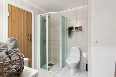 a bathroom with a toilet and a glass shower at Nice apartment with Sauna and ski in out Trysil in Trysil