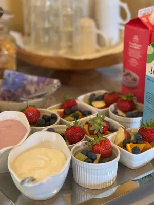 a bunch of bowls filled with fruit and dip at Eide Gardshotell in Skjolden