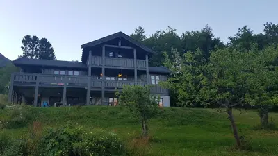 a large house on top of a hill with trees at Hatlen View in Isfjorden