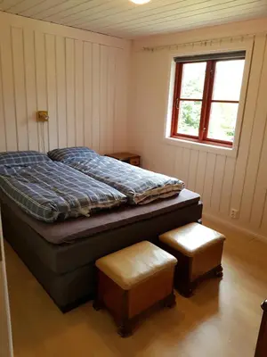 a bedroom with a bed and a window at Hatlen View in Isfjorden