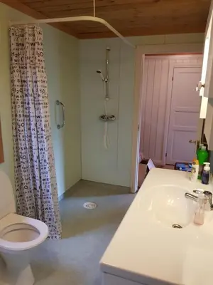 a bathroom with a toilet and a sink and a shower at Hatlen View in Isfjorden