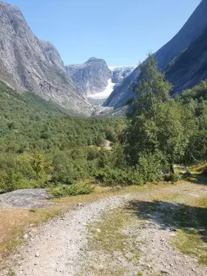 a dirt road in the middle of a mountain at Sjarmerende feriehus i Olden rett ved fjorden in Stryn