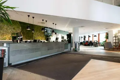 a lobby of a restaurant with a counter at Scandic Lerkendal in Trondheim