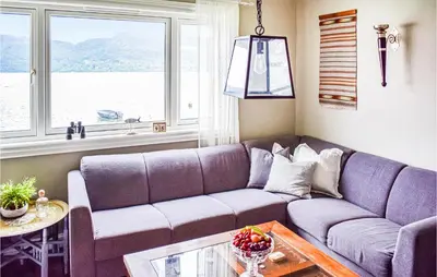 a living room with a couch and a table at Lovely Home In Hebnes With Wifi in Hebnes