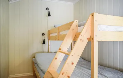 a bunk bed in a small room with a ladder at Lovely Apartment In Hebnes in Hebnes