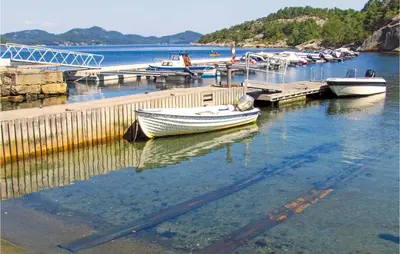 a group of boats docked at a dock in the water at 3 Bedroom Awesome Home In Skjold in Skjold