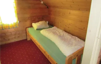 a small room with a bed in a log cabin at Holiday Home Bjoa Haugsgjerdet Ii in Utbjoa