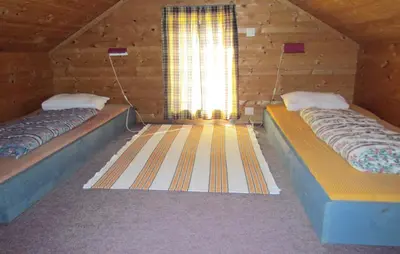 two beds in a room with a window at 3 Bedroom Gorgeous Home In Bjoa in Utbjoa
