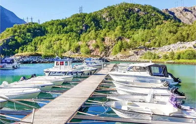 a group of boats docked at a dock in the water at Ytre Matre in Hamre