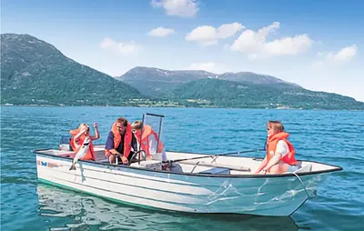 a group of people in a boat on the water at Kyrping Ferieplass A in Erve
