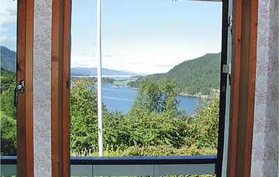 a view of a lake through a glass door at Holiday Home Etne Sørstranda in Erve