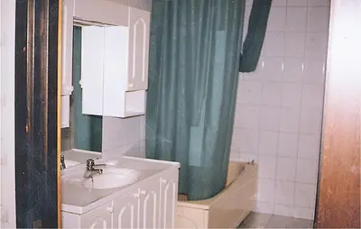 a bathroom with a sink and a shower curtain at Holiday Home Etne Sørstranda in Erve