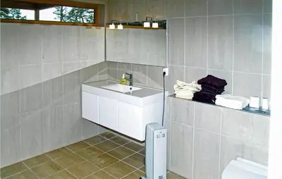 a bathroom with a sink and a toilet at 3 Bedroom Awesome Home In Mosterhamn in Mosterhamn