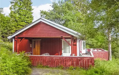 a red house with a red fence around it at Awesome Home In Sandvoll in Sandvoll
