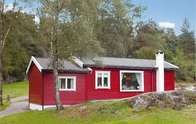 a red house with a white window and a tree at Nice Home In Etne With House Sea View in Erve