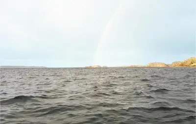 a large body of water with rocks in the distance at Holiday Home Finnås Lyklingsjøvegen in Vinnes