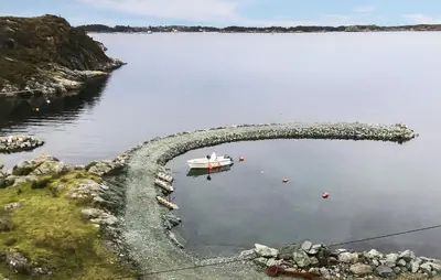 a boat in a body of water at Holiday Home Finnås Lykling in Vinnes