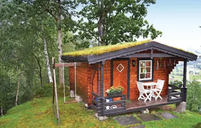 a small log cabin with a grass roof at Cozy Home In Norheimsund in Norheimsund
