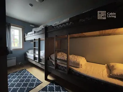 two bunk beds in a room with a window at Nice apartment in Trysil ski in-out, sauna and view in Trysil