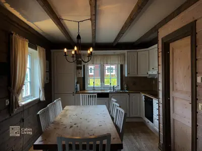 a kitchen with a wooden table and chairs and a dining room at Nice apartment in Trysil ski in-out, sauna and view in Trysil