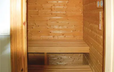 a wooden sauna with a bench in it at Nice Apartment In Rosendal With Sauna in Rosendal