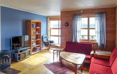 a living room with a couch and a table at Nice Apartment In Rosendal With Sauna in Rosendal