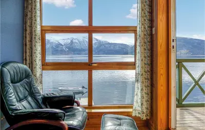 a room with a chair and a window with a view at Nice Apartment In Rosendal With Sauna in Rosendal
