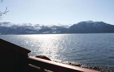 a view of a body of water with snow covered mountains at Holiday Home Ålvik Ytre Ålvik in Ålvik