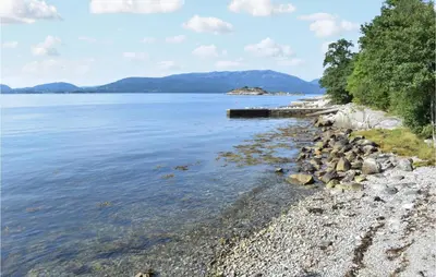 a rocky shore of a body of water at Eikhaugen Gjestegard in Husa