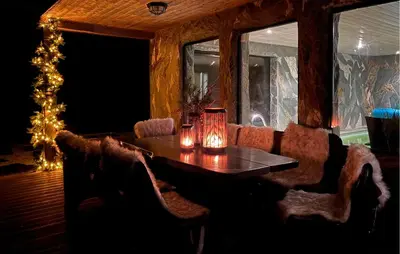 a dining room with a table and a christmas tree at Raaen Hytteutleige in Utne