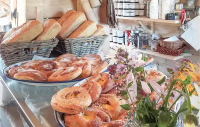 a bakery with several plates of bread on display at Eikhaugen Gjestegard in Husa