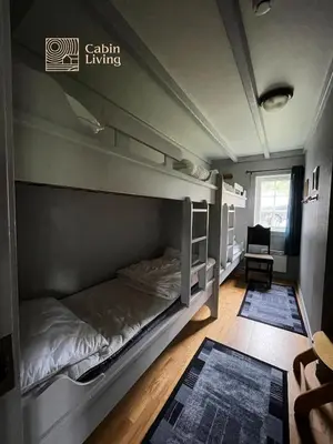 a bedroom with a bunk bed and a chair at Great apartment in Trysil, ski inout, wifi, sauna in Trysil