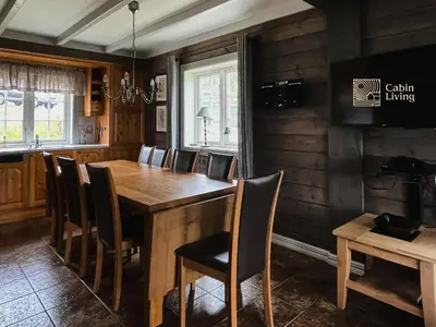 a dining room with a wooden table and chairs at Great apartment in Trysil, ski inout, wifi, sauna in Trysil