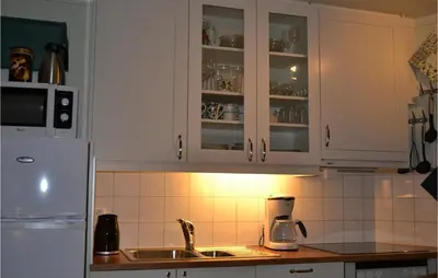 a kitchen with white cabinets and a sink at Cozy Apartment In Norheimsund With Wifi in Norheimsund