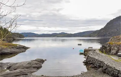 a view of a large body of water with mountains at Beautiful Home In Nordtveitgrend in Haugen