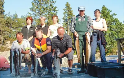 a group of people posing with their catch of fish at Beautiful Home In Hatlestrand in Hatlestrand