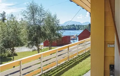 a view from the porch of a house with a white fence at Cozy Home In Hatlestrand With Sauna in Hatlestrand