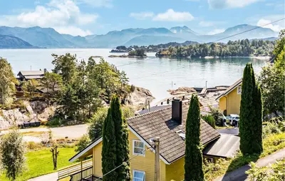 a house with a view of a lake at Cozy Home In Hatlestrand With Sauna in Hatlestrand